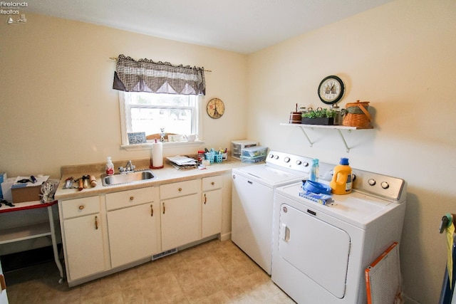 clothes washing area featuring sink and washing machine and dryer