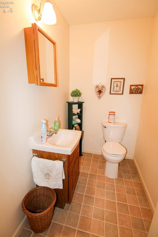 bathroom featuring tile patterned flooring, vanity, and toilet