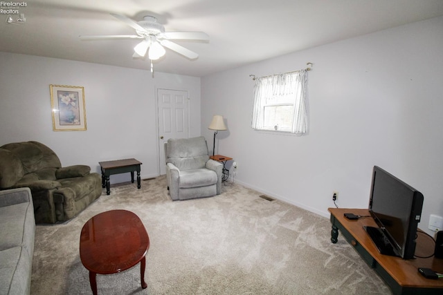 carpeted living room featuring ceiling fan