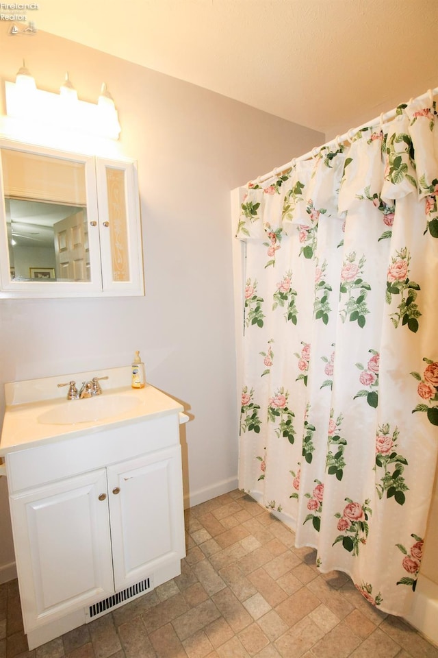 bathroom with vanity and curtained shower