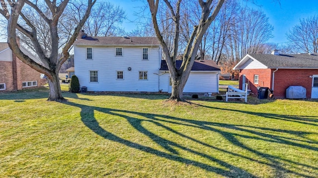 rear view of house with a lawn