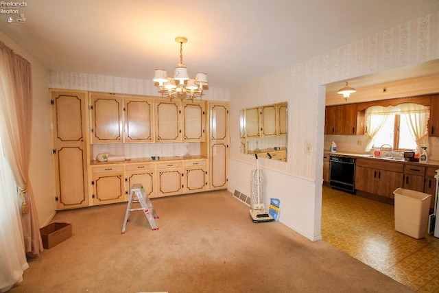 kitchen featuring pendant lighting, sink, a chandelier, and black dishwasher