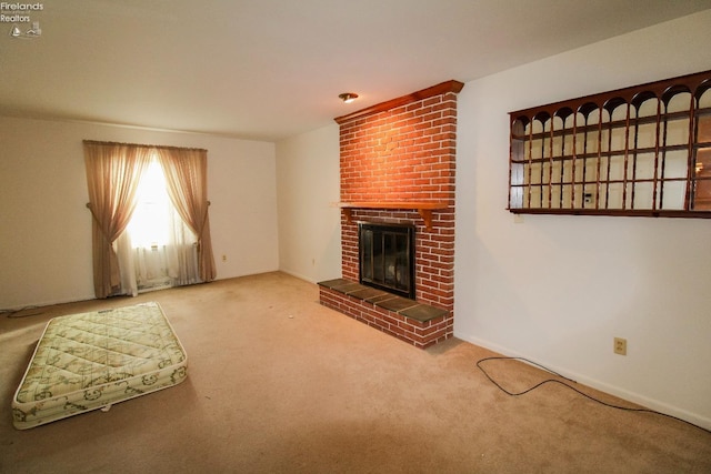 unfurnished living room featuring a brick fireplace and carpet flooring