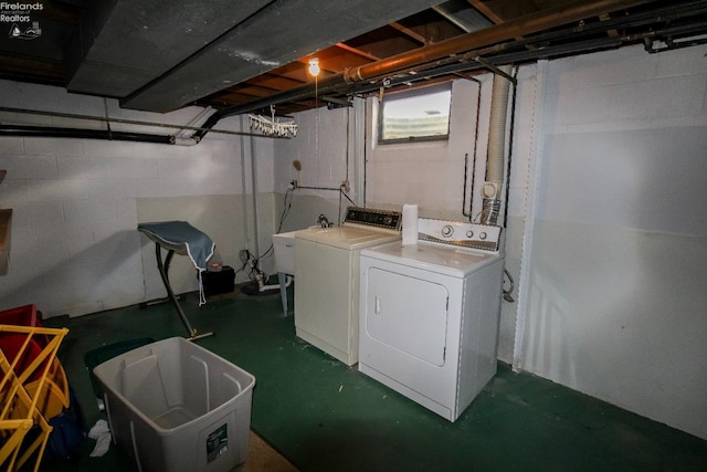 clothes washing area featuring sink and washing machine and clothes dryer