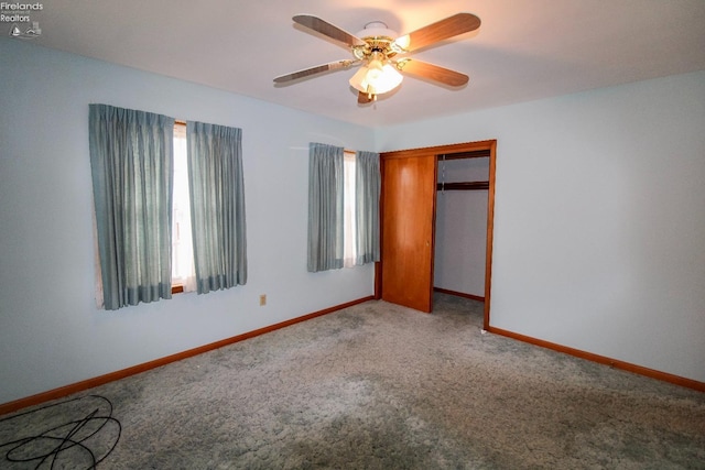 unfurnished bedroom featuring ceiling fan, carpet floors, and a closet