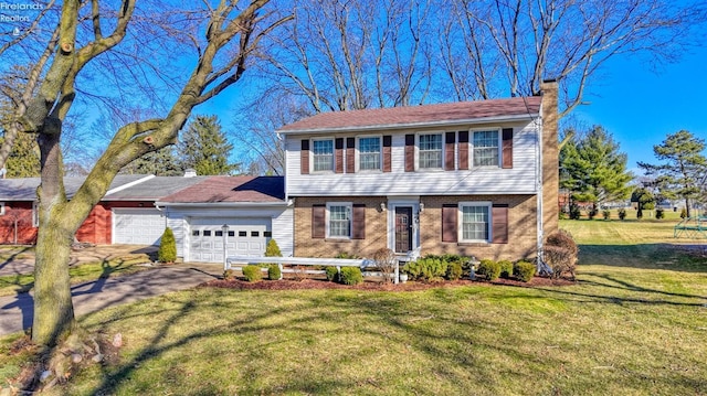 colonial house with a garage and a front lawn