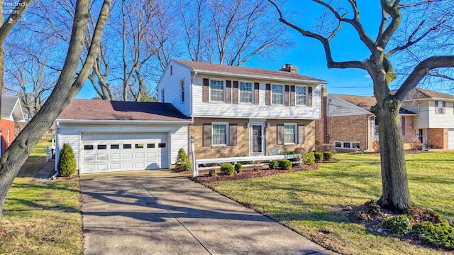 view of front of house featuring a garage and a front lawn