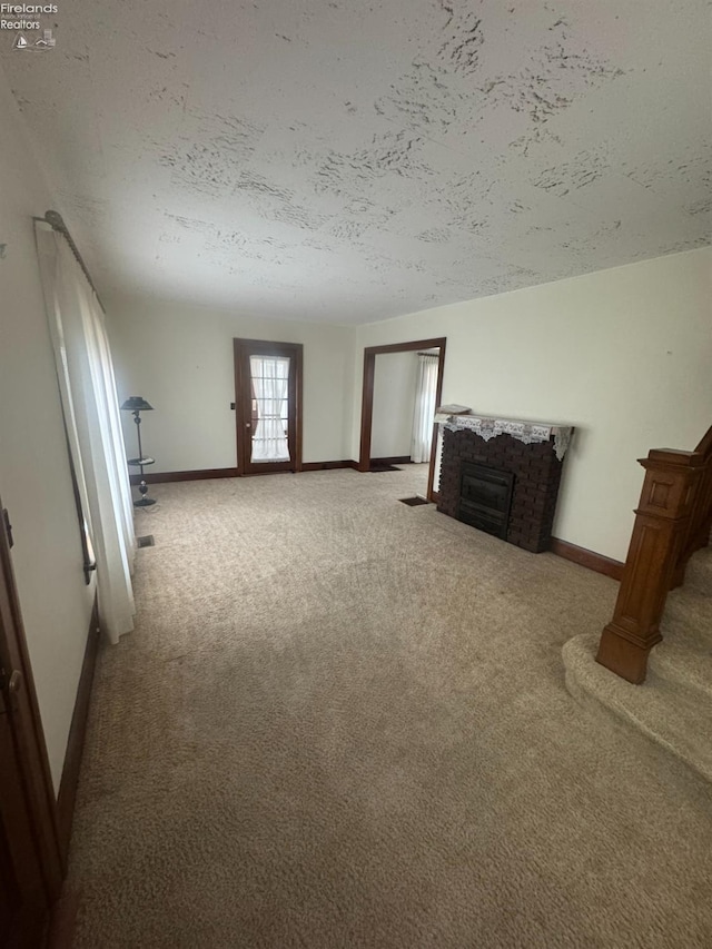 unfurnished living room with a textured ceiling and carpet