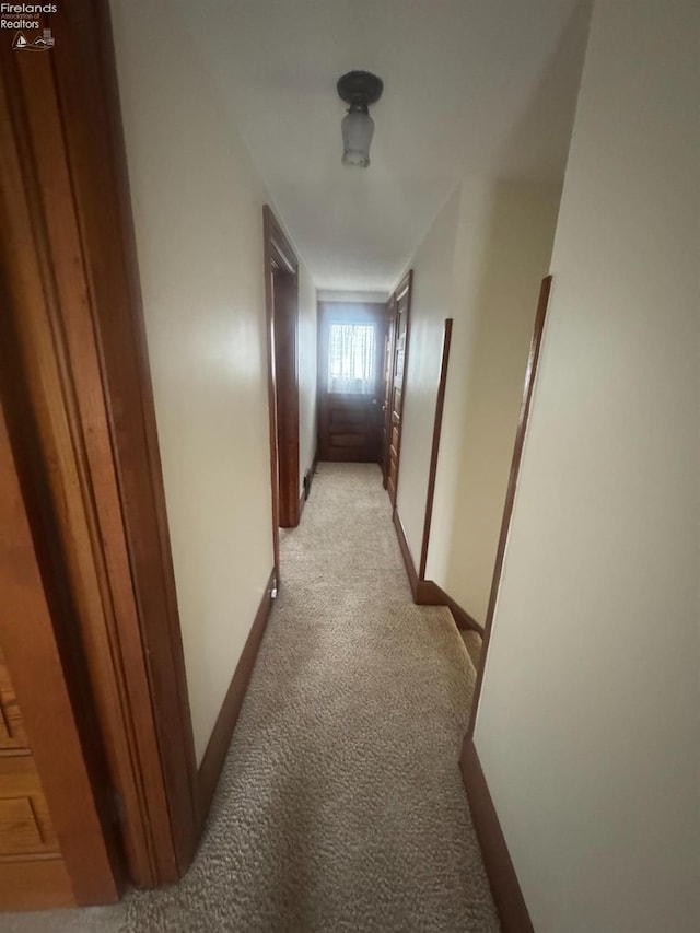 hallway with light colored carpet