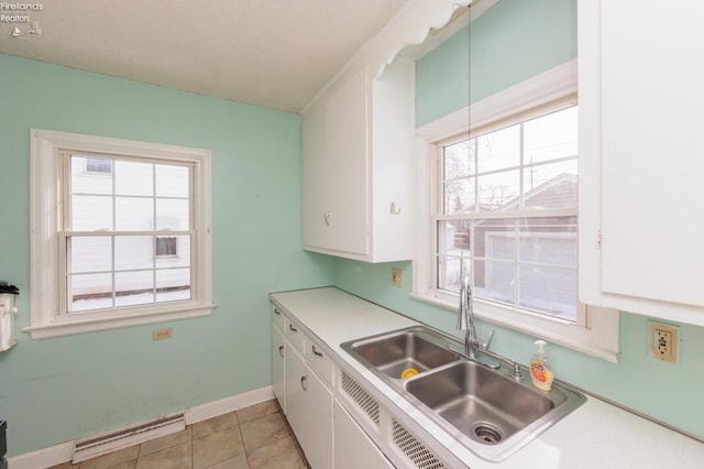 kitchen featuring a wealth of natural light, sink, and white cabinets