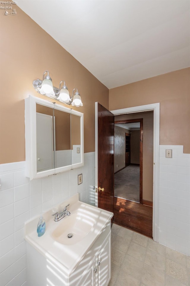 bathroom with tile walls and vanity