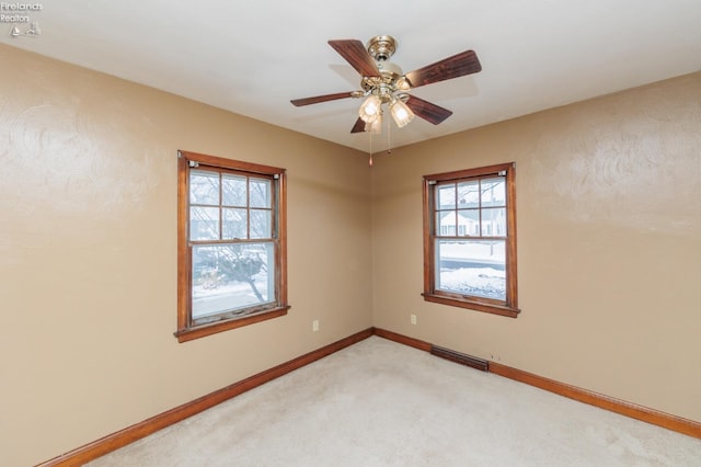 carpeted empty room featuring ceiling fan