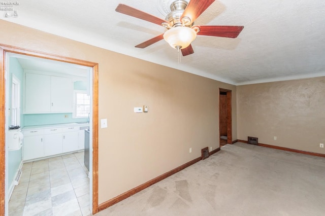 empty room featuring ceiling fan and a textured ceiling