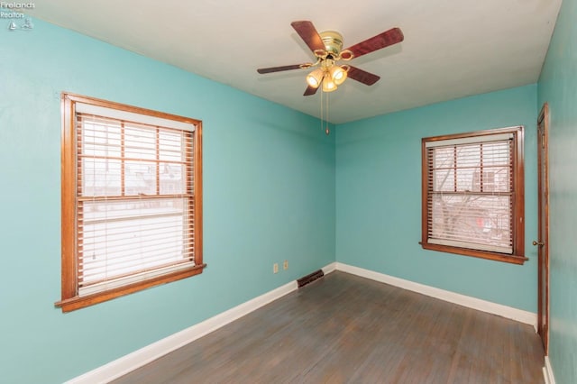 unfurnished room with dark wood-type flooring and ceiling fan