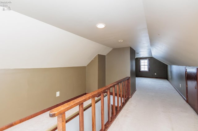 additional living space featuring light colored carpet and lofted ceiling