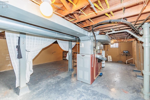 basement with gas water heater and heating unit