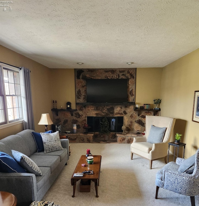 living room with light carpet, a textured ceiling, and a fireplace