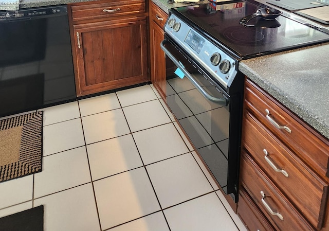 kitchen with light tile patterned floors and black appliances