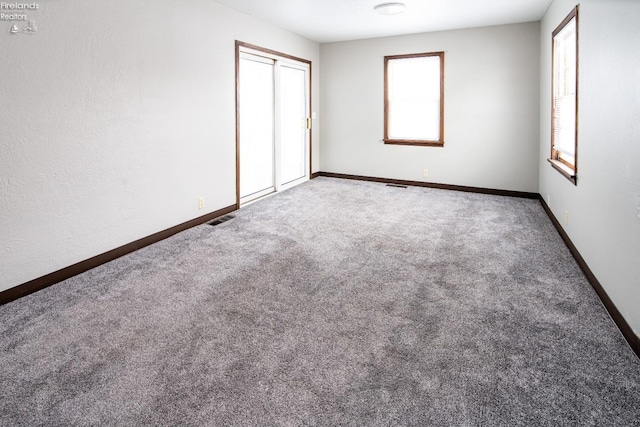 unfurnished bedroom featuring carpet, a closet, visible vents, and baseboards