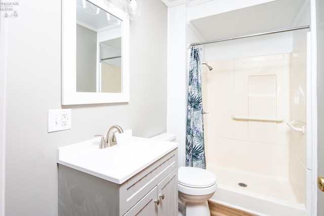 bathroom with toilet, wood finished floors, a shower stall, and vanity