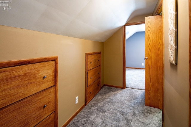 additional living space with vaulted ceiling, carpet, and baseboards