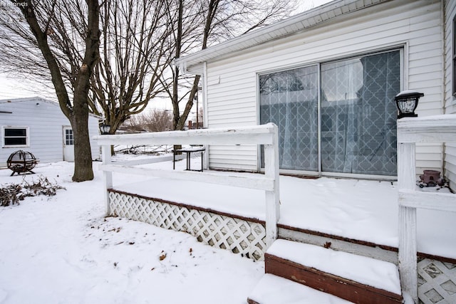 snow covered deck with a garage