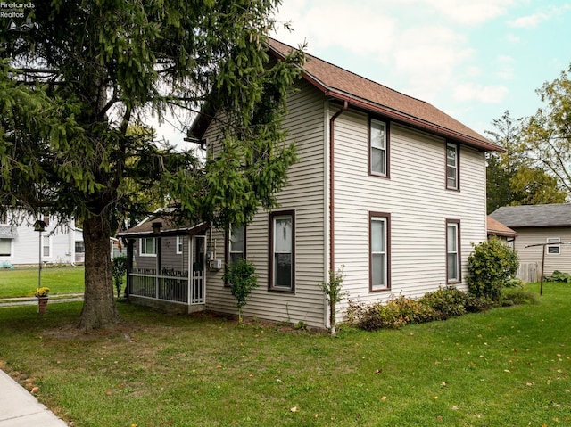 view of side of property with a yard