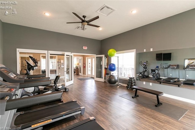 exercise room with hardwood / wood-style floors, french doors, and ceiling fan