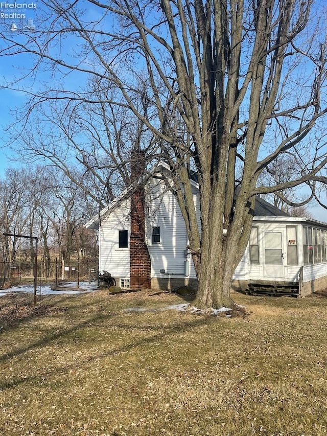 view of side of home featuring a yard