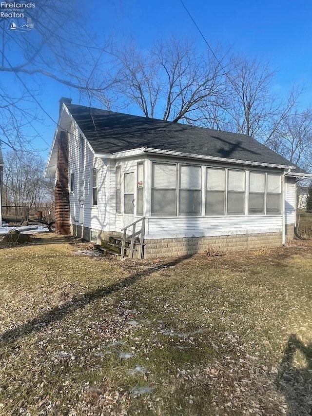 view of side of home featuring a lawn