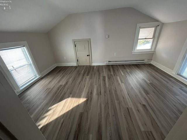 bonus room with a baseboard radiator, lofted ceiling, and dark hardwood / wood-style flooring