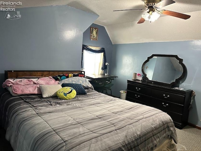 carpeted bedroom featuring lofted ceiling, ceiling fan, and a textured ceiling