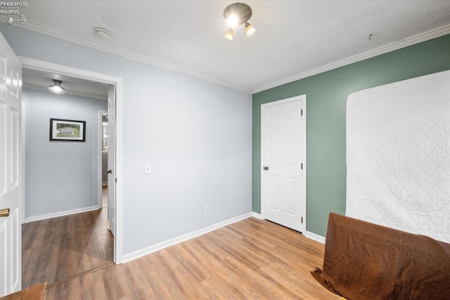 unfurnished room featuring ornamental molding and hardwood / wood-style floors