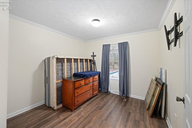 bedroom featuring dark hardwood / wood-style flooring, crown molding, and a textured ceiling