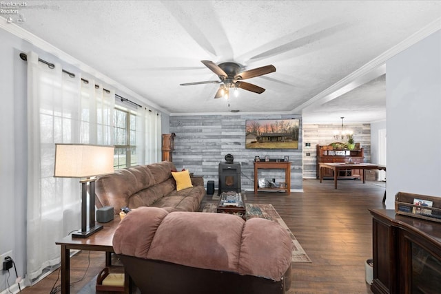 living room featuring crown molding, dark hardwood / wood-style floors, a wood stove, and a textured ceiling