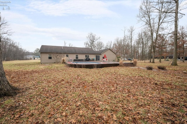 rear view of house with a swimming pool side deck