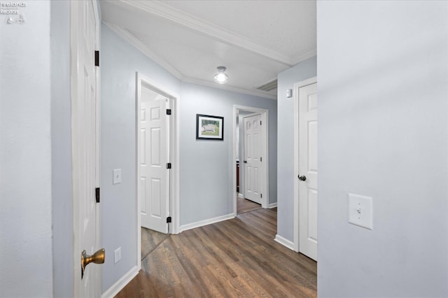 hall featuring ornamental molding and dark wood-type flooring