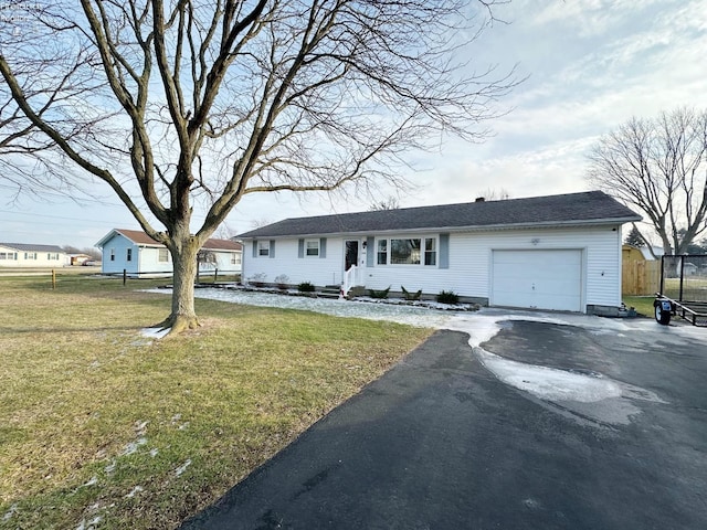 single story home featuring a garage and a front lawn