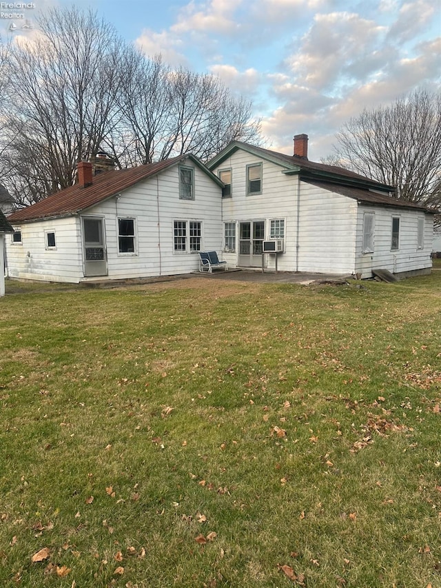 73 Center, Milan, OH 44846 - back of house featuring a patio, cooling unit, and a lawn
