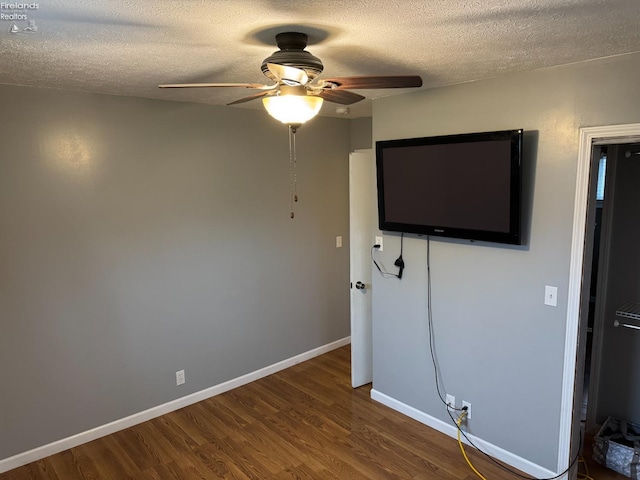 unfurnished bedroom featuring hardwood / wood-style floors, a textured ceiling, and ceiling fan