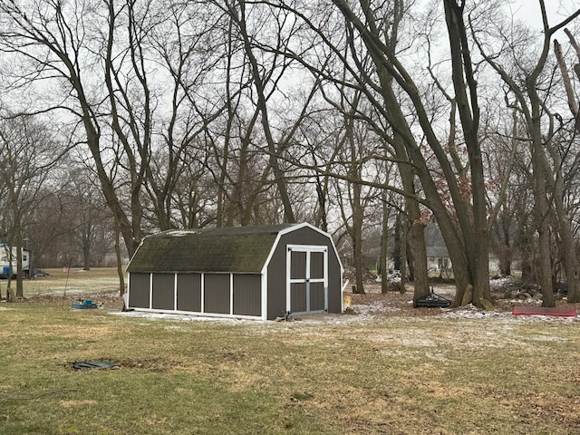 view of outbuilding with a yard