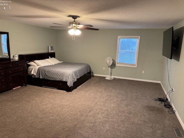 carpeted bedroom with ceiling fan and a textured ceiling