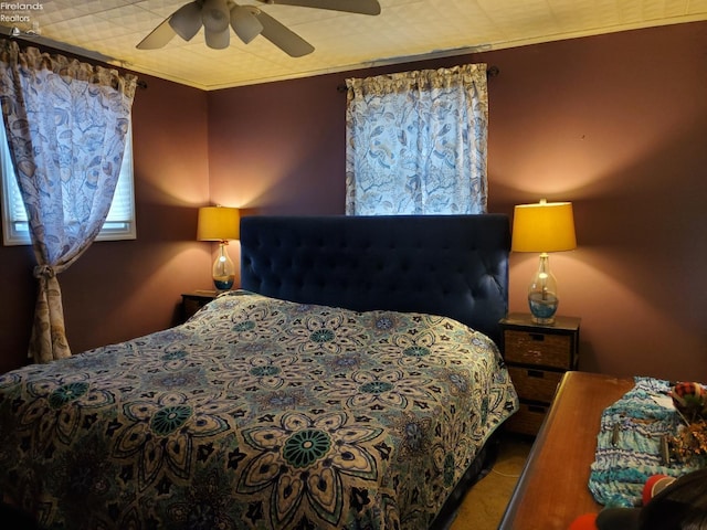 bedroom featuring ornamental molding and a ceiling fan