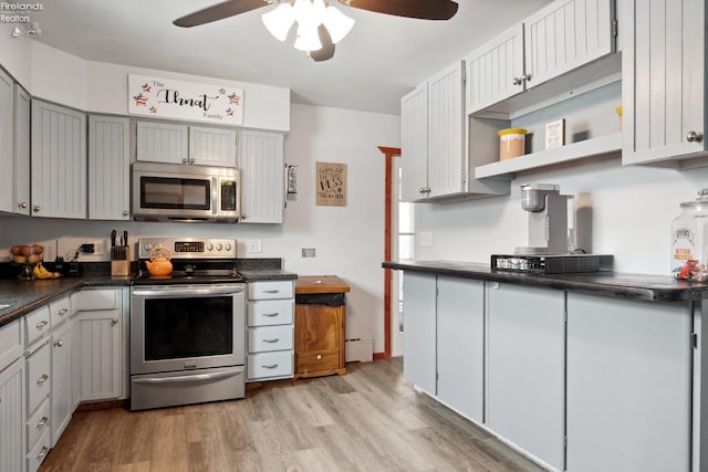 kitchen featuring gray cabinets, a baseboard heating unit, ceiling fan, light hardwood / wood-style floors, and stainless steel appliances