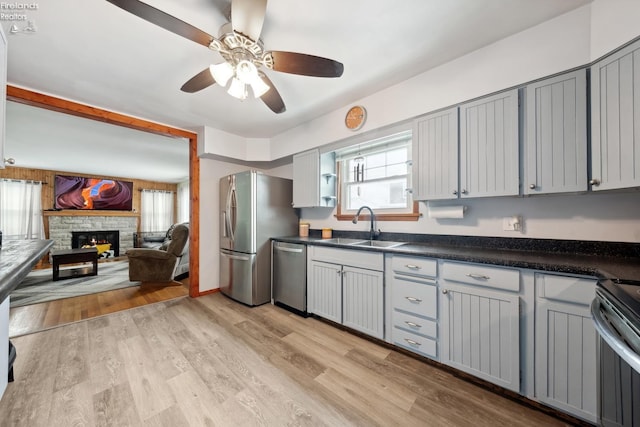 kitchen featuring gray cabinetry, sink, stainless steel appliances, and light hardwood / wood-style floors