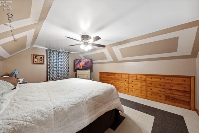 carpeted bedroom with vaulted ceiling and ceiling fan