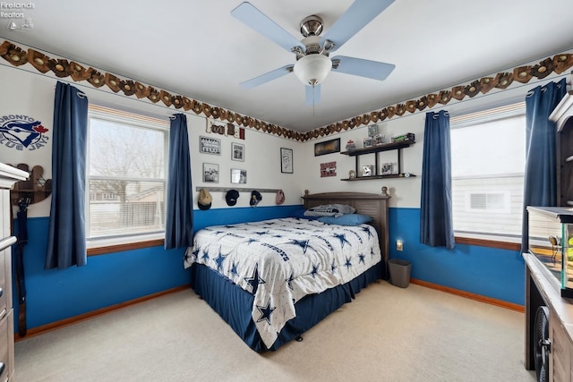 bedroom with multiple windows, light carpet, and ceiling fan