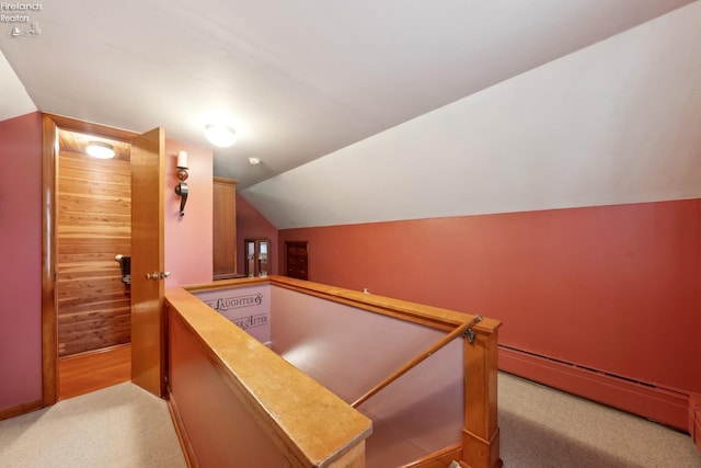 bar featuring lofted ceiling, light carpet, and a baseboard heating unit