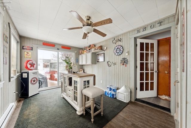 interior space featuring ceiling fan, a baseboard radiator, and dark hardwood / wood-style floors