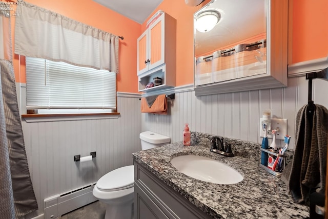 bathroom featuring vanity, a baseboard heating unit, and toilet